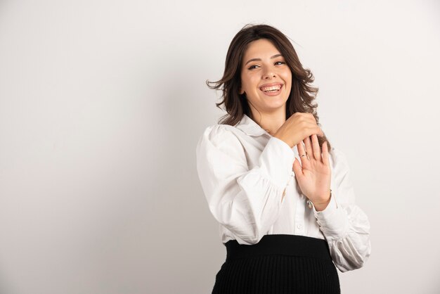 Young employee showing her hand while smiling.