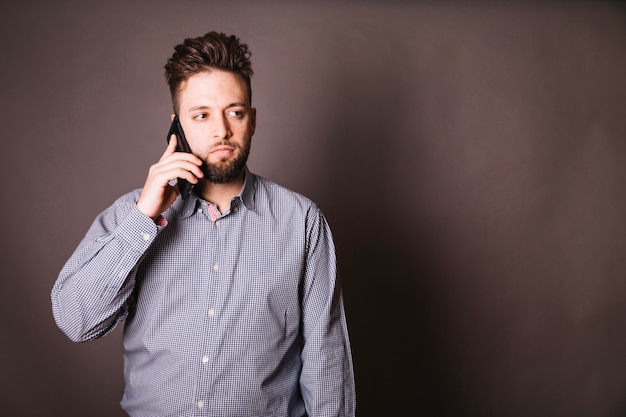 Young employee talking on phone