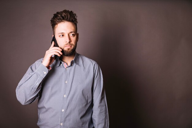 Young employee talking on phone