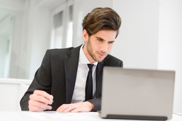 Young employee working on his report