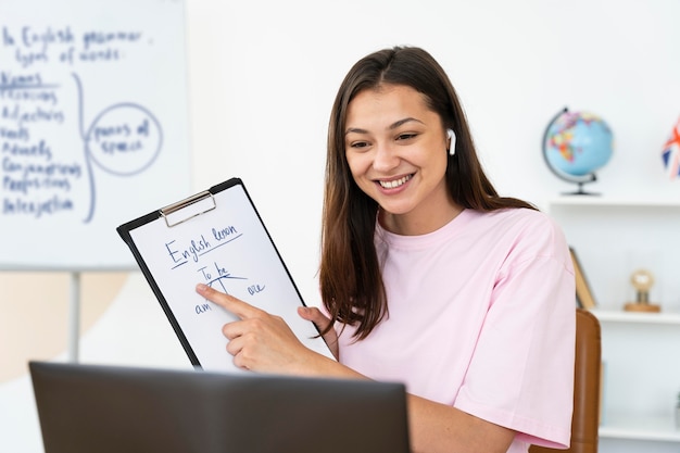 Young english teacher doing her class online