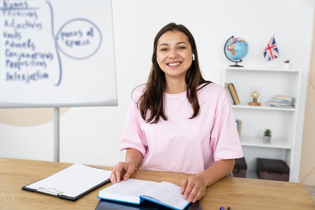 Free photo young english teacher doing her class online