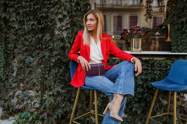 Young european  confident woman with   candid smile posing outdoor in the bar