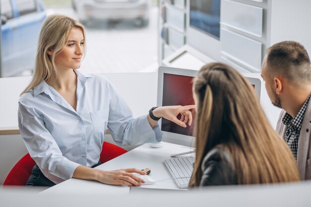 Young family buying a car at a dealer