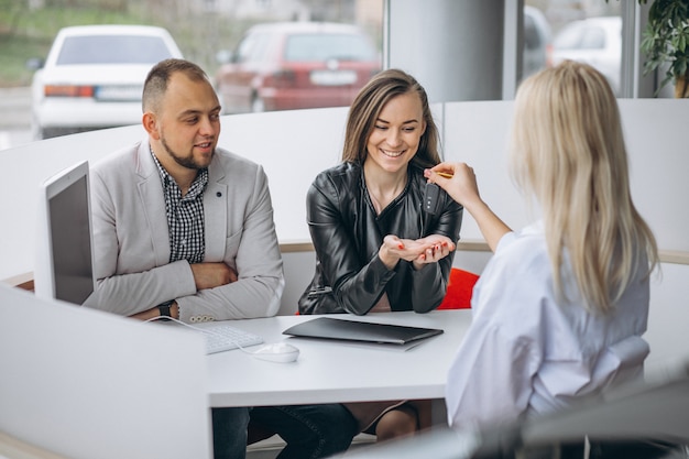 Young family buying a car at a dealer