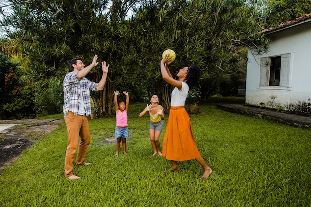 Free photo young family playing ball in the park