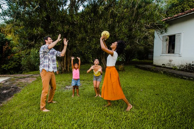 Young family playing ball in the park