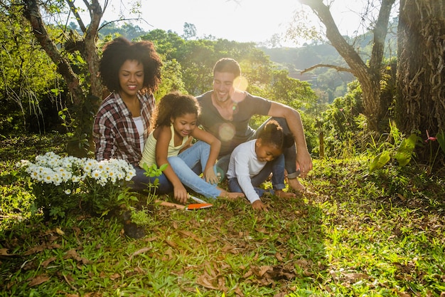 Young family sitting in forest