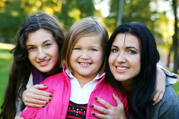 Young family taking healthy stroll through autumn park