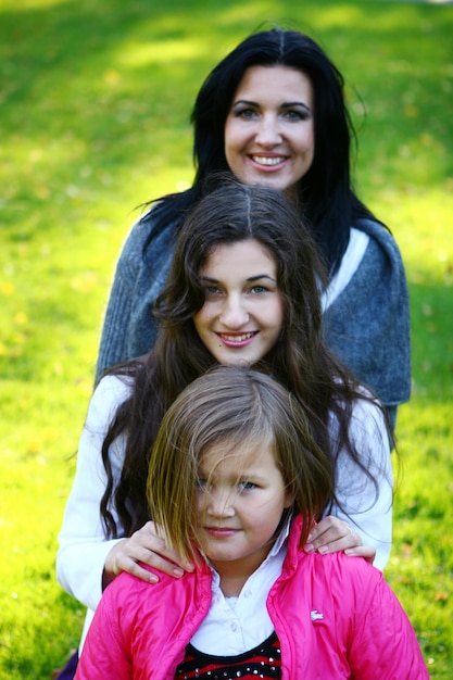 Young family taking healthy stroll through autumn park