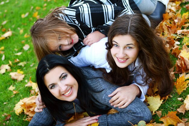 Young family taking healthy stroll through autumn park
