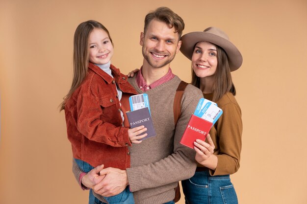 Young family of three posing together before travel vacation