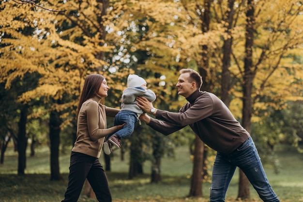 Free photo young family with baby son in park