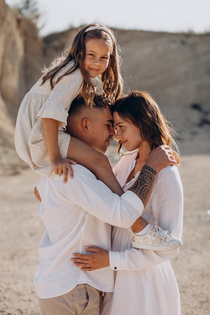 Young family with daughter walking out together