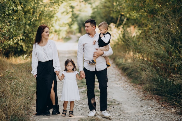 Young family with kids in forest together