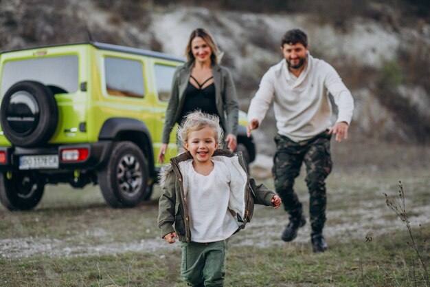 Young family with little daughter stopped in forest