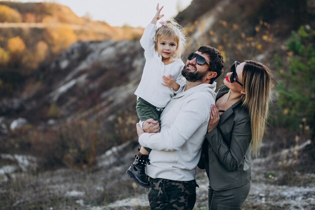 Young family with little daughter stopped in forest