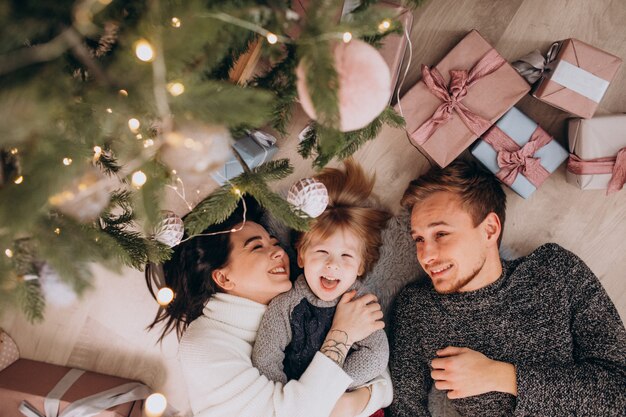 Young family with little son under the Christmas tree