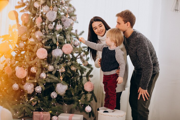 Free Photo young family with little son decorating christmas tree
