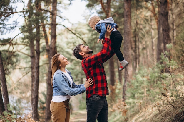 Young family with little son in forest