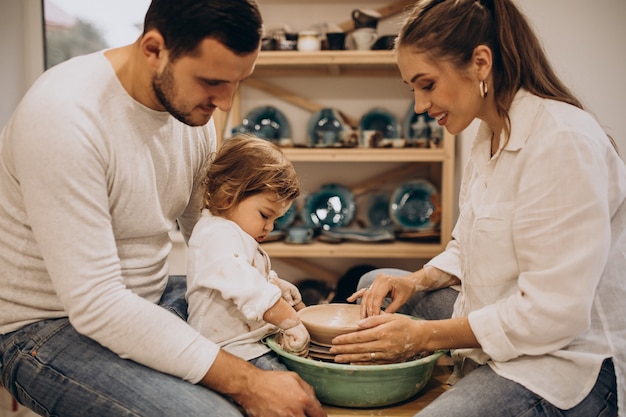 Young family with little son at a pottery class
