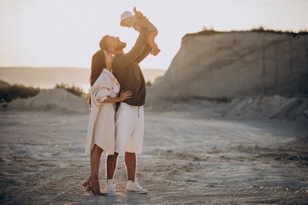 Young family with little son on the sunset