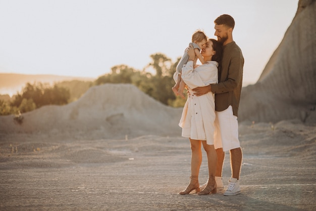 Young family with little son on the sunset