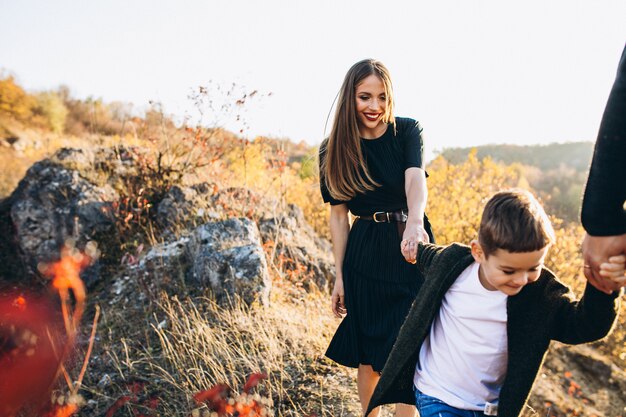 Young family with little son walking in park