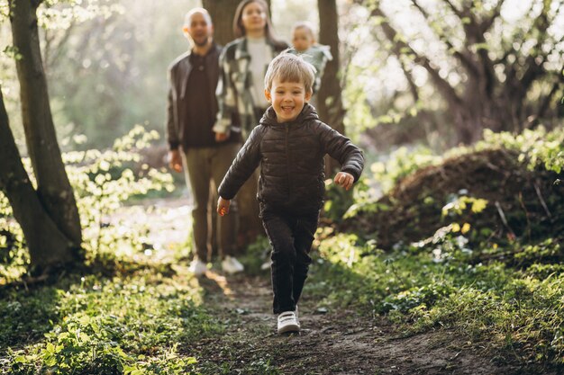 Young family with their kids having fun in the forest