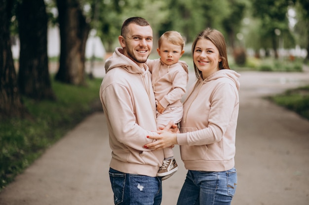 Free photo young family with their little baby child in park