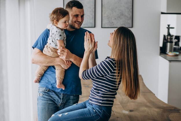 Young family with their little son at home