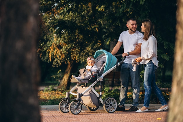 Young family with their small daughter in autumn park