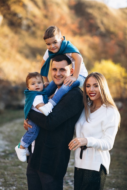 Young family with two sons together outside the park