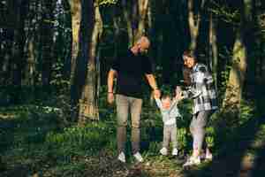 Free photo young fanily with little daughter in the forest