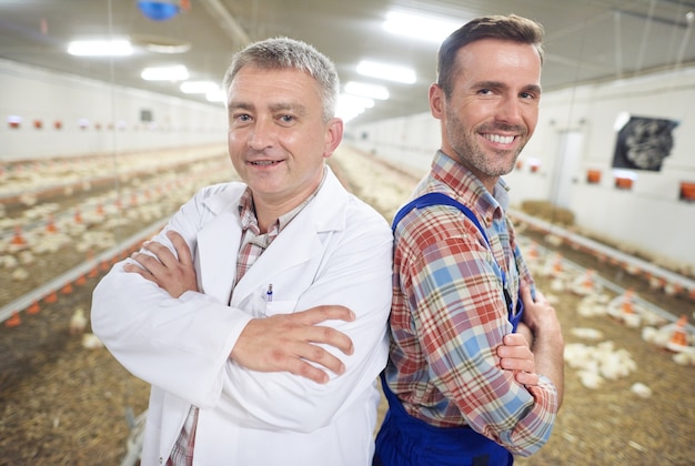 Free photo young farmer with doctor checking the health of animals