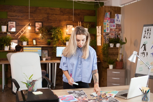 A young fashion designer in creative office looking for inspiration.