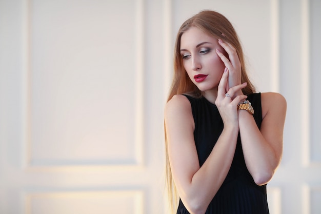 Young fashion woman posing with black dress