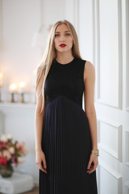 Young fashion woman posing with black dress