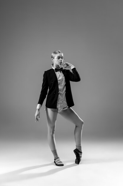 Young fashionable, stylish woman wearing jacket and socks working from home.