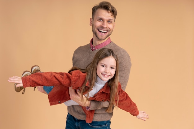 Free photo young father and daughter playing together before traveling