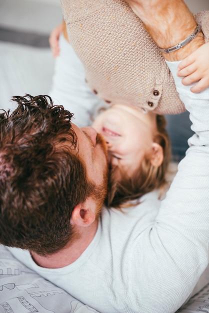 Foto gratuita giovane padre che bacia bambino