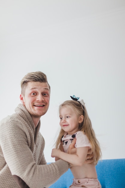 Young father playing with his daughter