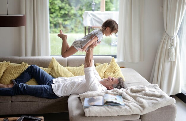 young father plays with his daughter at home