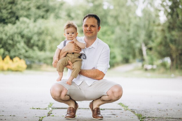 Young father with little son in park