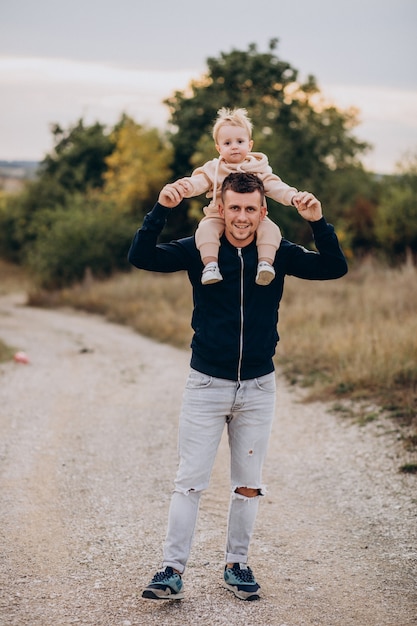 Foto gratuita giovane padre con il piccolo figlio nel parco