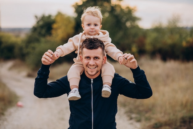 Free photo young father with little son in park