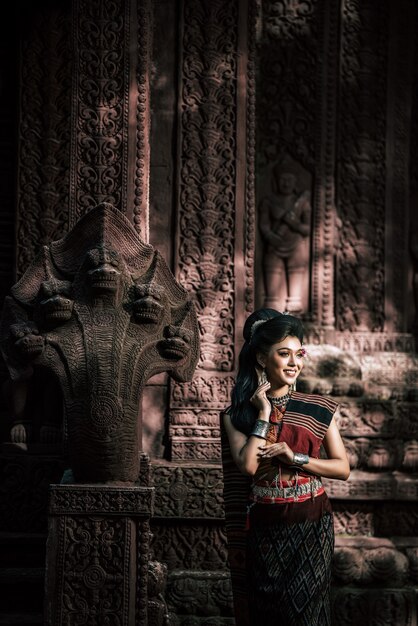 Young female Actress wearing beautiful ancient costumes, in ancient monuments, dramatic style. Perform on legend love popular story, Thai Isan folktale called "Phadaeng and Nang-ai" in acient site