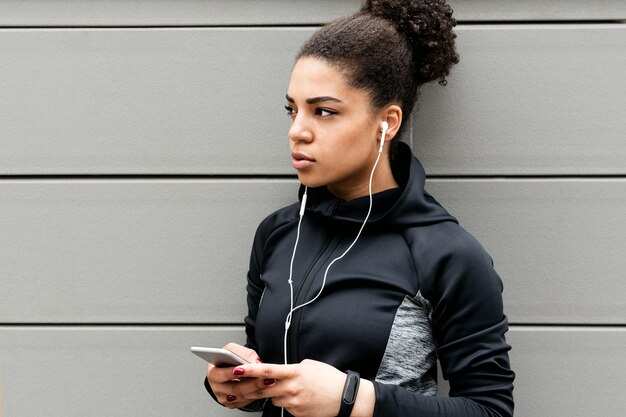 Young female athlete wearing headphones