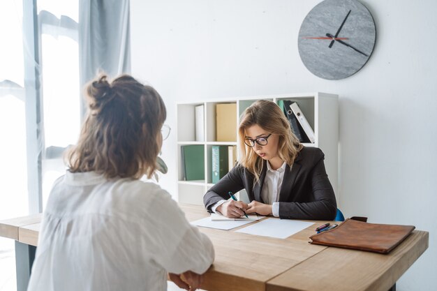 young female candidate interviewed by employer