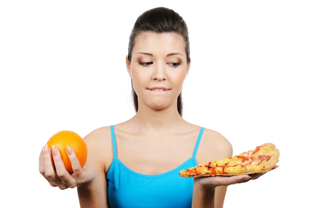 Free photo young female choose between pizza and orange - close-up